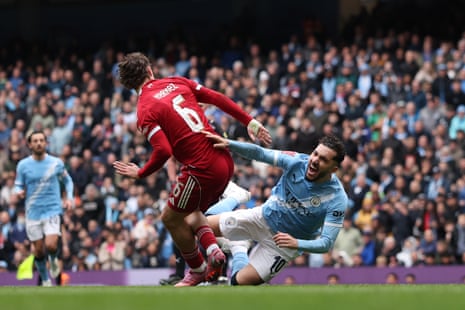 Rayan Cherki goes down under a challenge from Milos Kerkez.