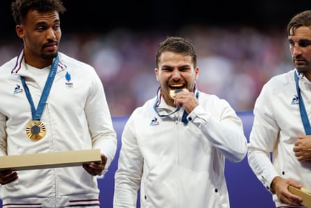 France's Antoine Dupont bites his gold medal during the Men’s Rugby Sevens Gold Medal match between France and Fiji.