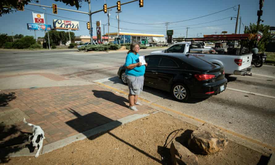 Becky Blackmon, 54 and homeless, panhandles with a sign reading “need help” at an intersection in Oklahoma City.