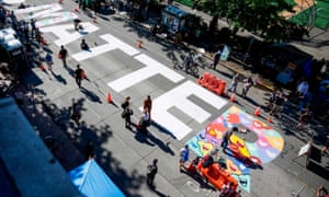 Protesters in Seattle’s Capitol Hill Autonomous Zone decorate their Black Lives Matter mural