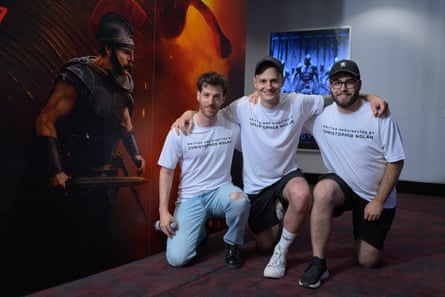 Friends Julian Jäger, Marco Garbely and Gilbert Oggier taking a knee by a film poster.