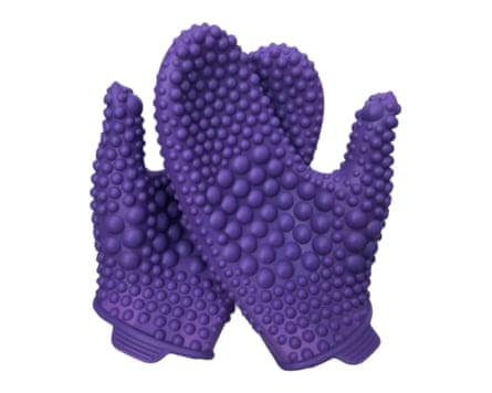 A pair of purple massage mitts which have patterned texture of different size nodules.