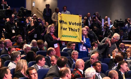 Two women hold banner