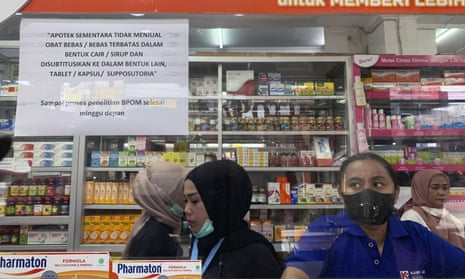 A pharmacy in Jakarta, Indonesia displays a sign that says the sale of medicinal syrup has been temporarily halted.