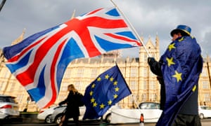 An anti-Brexit demonstrator waves a UK flag alongside a European Union flag outside the Houses of Parliament