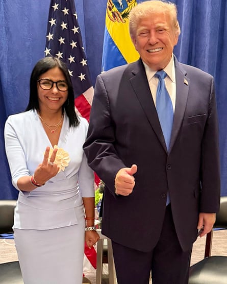 Rodriguez and Trump, who is giving a thumbs up sign stand smiling together