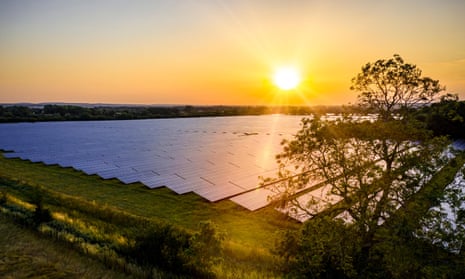A field full of solar panels at sunrise