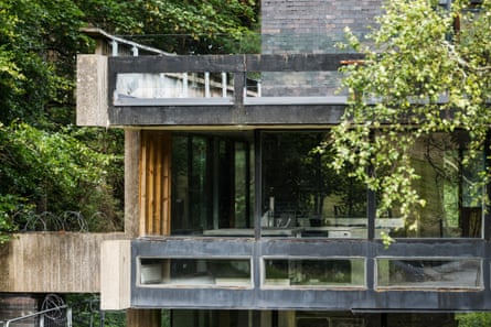 Close-up of modernist house in disrepair with razor wire