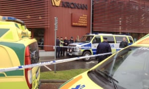 Swedish police officers secure the area outside a primary and middle school in Trollhättan