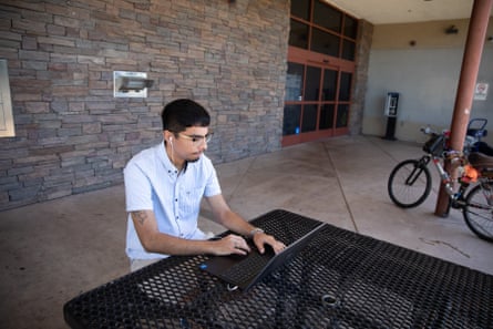 young man at laptop outdoors