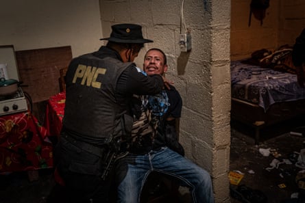 A PNC police officer subdues a gang member belonging to the Crazy Gangsters clica of the 18th Street gang