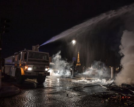 Police vehicle firing off a jet of water from a cannon on top of it