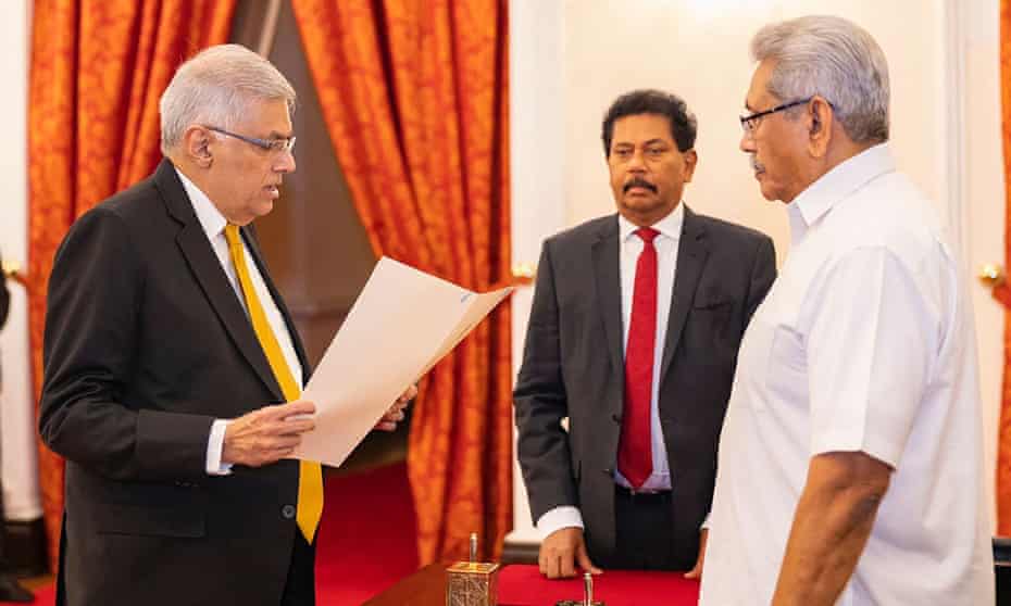 Ranil Wickremesinghe (left) attending his swearing-in ceremony before President Gotabaya Rajapaksa (right) at the presidential palace in Colombo on Thursday