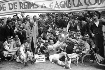 Reims’ players celebrate with trophy after their 3-1 victory over Nimes in the 1958 French Cup final.