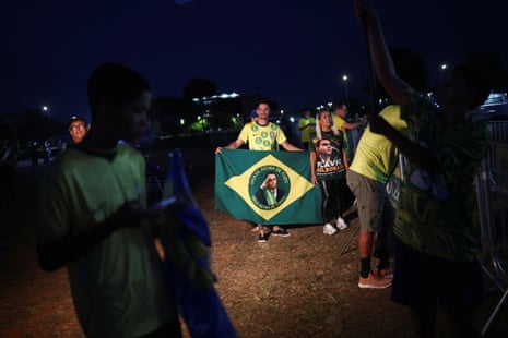 Supporters of Brazilian presidential candidate Flavio Bolsonaro attend an event on the street, waiting for the first results of the presidential runoff election, in Brasilia, Brazil, 25 October, 2026.