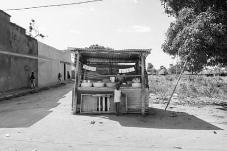 a child stands at a makeshift store
