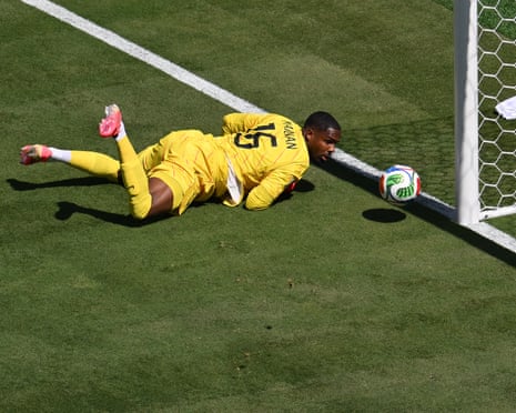 France's keeper Mike Maignan looks on as the ball goes inches wide after coming off the post and his boot.