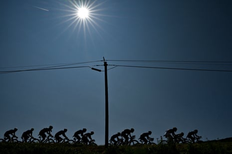 Riders silhouetted under the sun