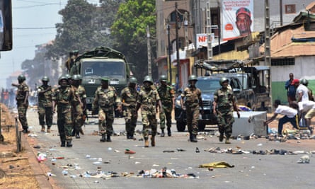 Protesters confront the army in the streets of Conakry on 22 March, the day of Guinea’s constitutional referendum