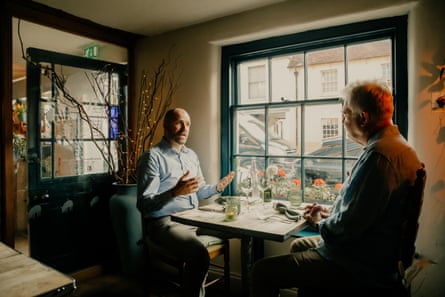 Ben and Neil chatting across a restaurant table