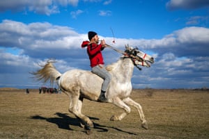 A local tradition in Pietrosani, Romania sees villagers have their horses blessed with holy water and then compete in race.