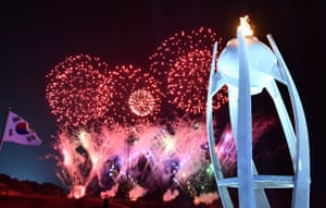 A final flourish of fireworks behind the Olympic torch.