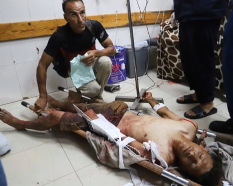 A Palestinian man who was injured at an aid distribution center run by the Gaza Humanitarian Foundation, a US-backed organisation approved by Israel, receives treatment on the floor of Nasser hospital in Khan Younis, southern Gaza Strip, on Saturday, 19 July 2025.