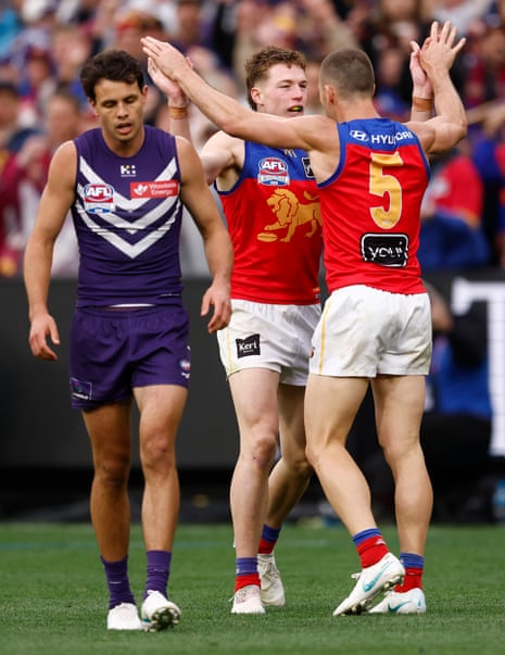 Logan Morris and Josh Dunkley celebrate as the Lions get back to within a kick of the Dockers
