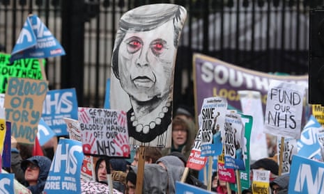 Protesters hold a placard of Theresa May during a march last weekend calling for an end to the NHS crisis.
