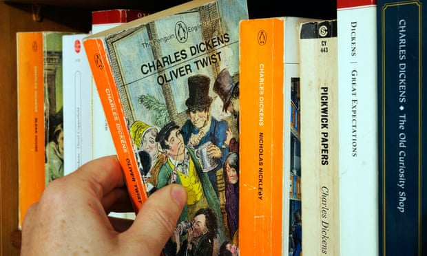 Picking a pocket book ... a hand removing a copy of Oliver Twist from its shelf.