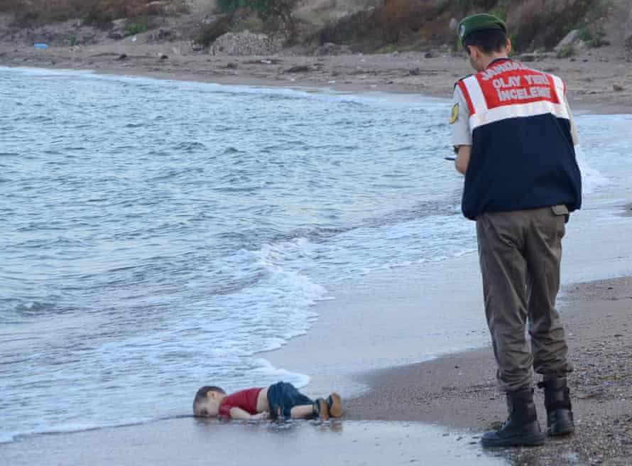 Young boy washed up on the beach.