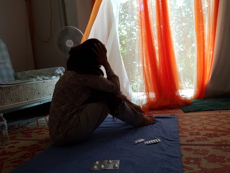 A young Afghan refugee woman, separated from her parents in Australia, looks out of the tent where she has lived for the past five years in Nauru. March 2018
