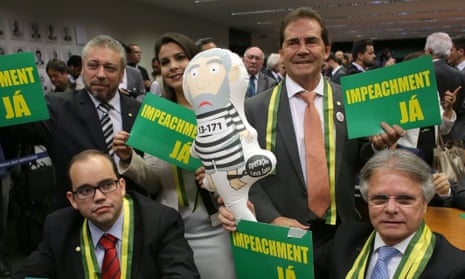 Opposition deputies show posters that read in Portuguese ‘impeachment now’ and an inflatable doll in the likeness of former president Luiz Inacio Lula da Silva in prison garb, during impeachment talks in Brasilia on Wednesday.