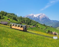 Mt. Stanserhorn, Switzerland - 8 May, 2016: springtime view from the foot of Mt. Stanserhorn, people in a car of the Stanserhorn funicular railroad, sMDWY7G Mt. Stanserhorn, Switzerland - 8 May, 2016: springtime view from the foot of Mt. Stanserhorn, people in a car of the Stanserhorn funicular railroad, s
