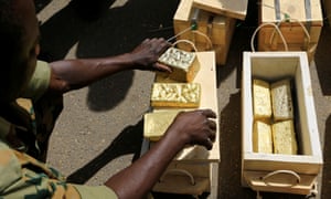 Sudanese Rapid Support Forces display gold bars seized from a plane that landed at Khartoum airport as part of an investigation into possible smuggling
