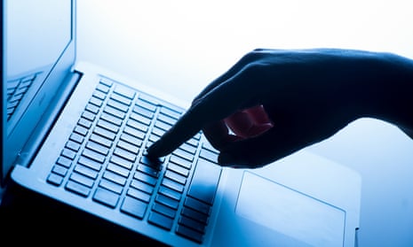 A woman's hand presses a key of a laptop keyboard
