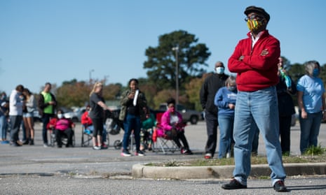 Voters wait in line to cast ballots in Effingham, South Carolina. The US experienced a historic turnout rate of 65.1% – the highest in over 100 years.