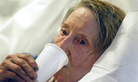 An elderly woman who wished to remain unidentified drinks after she was brought by firefighters to the Saint Antoine hospital in Paris during a 2003 heatwave.