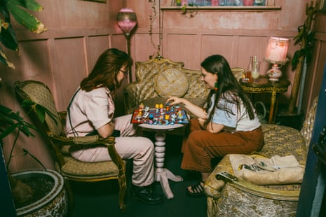 two women playing chess in a cosy corner 