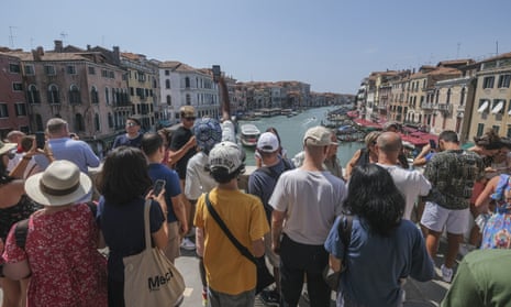 Tourists flock to the Rialto Bridge on August 02, 2023 in Venice, Italy.