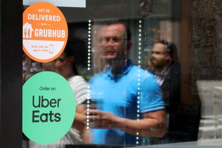 Grubhub and Uber Eats signs are displayed on a store front