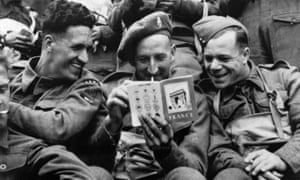British soldiers read a tourist guide about France on D-Day