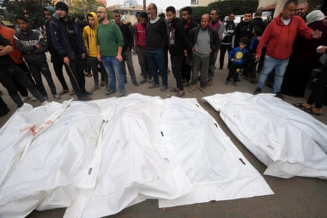 Palestinians mourn relatives killed in the Israeli bombing of the Gaza Strip in Deir al Balah on Thursday 28 December.