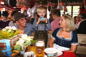 Philipp Lahm and his wife Claudia look on as their son Julian shows off some gingerbread