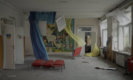 A bombed-out room with curtains blowing in the wind