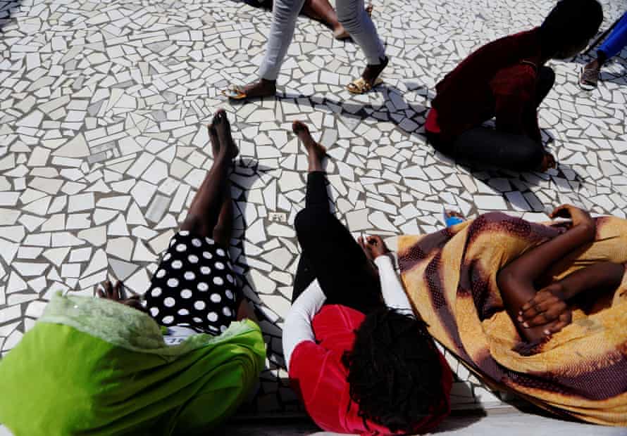A young woman who said she was raped by her friend sits with others at La Maison Rose, Dakar, Senegal