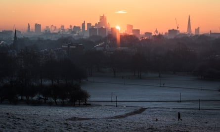 The sun rises over a snowy Primrose Hill, north-west London.