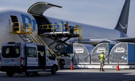 Grounds crew members load cargo into an Amazon Prime Air aircraft at the company's air hub in Hebron, Kentucky.