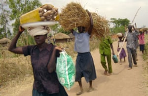 At the peak of its terror, the Lord’s Resistance Army was known worldwide for its cruelty. Here villagers are pictured fleeing their homes in the northern Ugandan village of Alito in 2006 following an attack by the rebel group