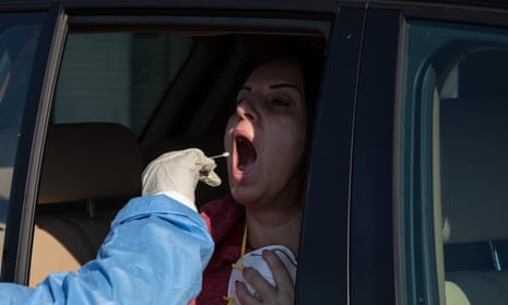 A patient is tested at a drive-though centre in Cinisello, Italy